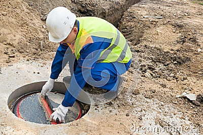 The urban communications worker opens the door for inspection Stock Photo