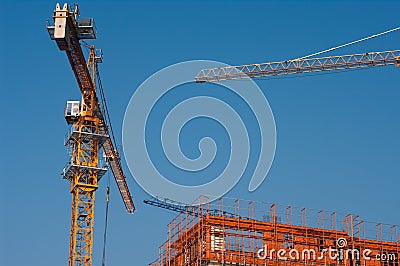 Urban construction site and tower cranes Stock Photo