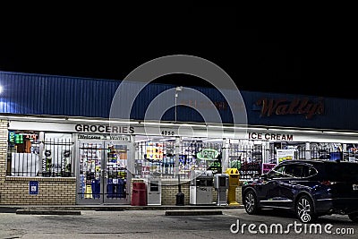 Urban convenience store at night parked cars open late Editorial Stock Photo