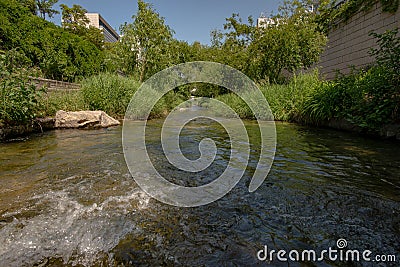 Urban creek showing running clear water Stock Photo