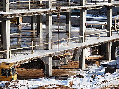 urban development. construction site in winter during the day. workers in uniform prepare the scaffolding Editorial Stock Photo