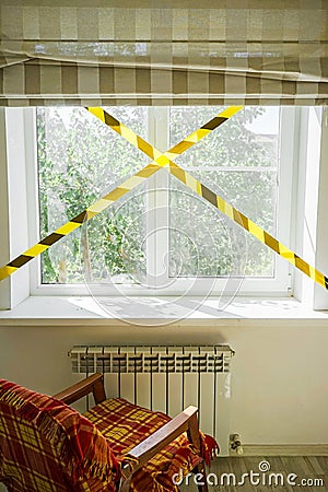 Urban environment is prohibited. view from the window. restraining tape on the background of the window and trees. self-isolation Stock Photo