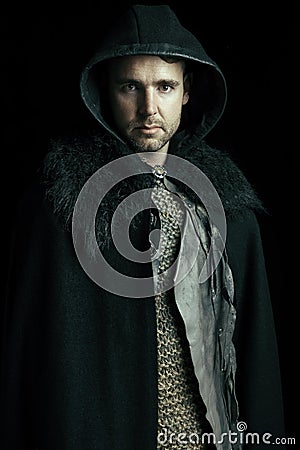 An urban fantasy or high fantasy man wearing a mail shirt, leather jerkin and cloak Stock Photo