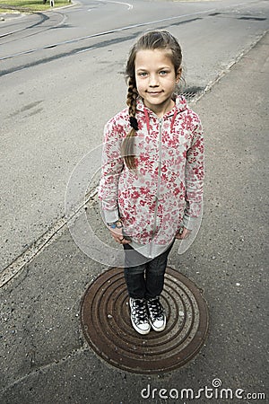 Urban girl on hatch Stock Photo