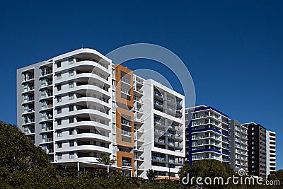 Urban high rise apartment condominiums community against blue sky Stock Photo