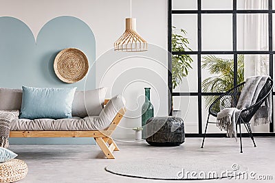 Urban jungle in bright white and blue living room interior with scandinavian futon sofa Stock Photo