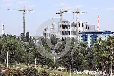 Urban landscape. Sleeping area of the city, ghetto. New buildings and building cranes. Ukrainian city, Kyiv. Postcard Stock Photo