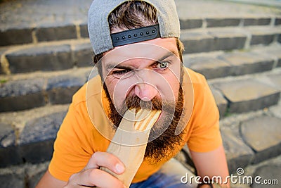 Urban lifestyle nutrition. Junk food. Carefree hipster eat junk food while sit stairs. Guy eating hot dog. Snack for Stock Photo