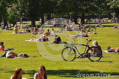 Urban lifestyle - people sunbathing in city park, Copenhagen Editorial Stock Photo