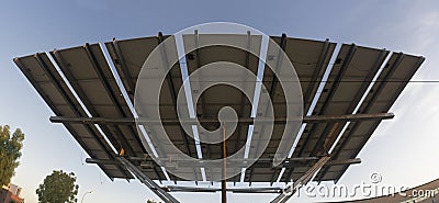 Urban photovoltaic panel with solar tracker placed outdoors building Stock Photo