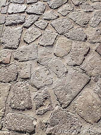 Sardinia. Traditional architecture. Urban road paved with rough ashlars of local volcanic stones. Detail Stock Photo