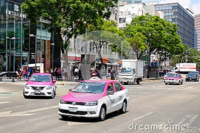 Urban scene with traditional pink taxis in downtown Mexico City Editorial Stock Photo