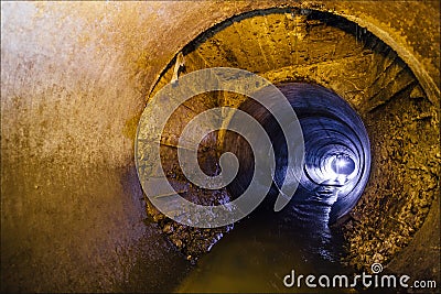 Urban sewage flowing throw round sewer tunnel pipe Stock Photo