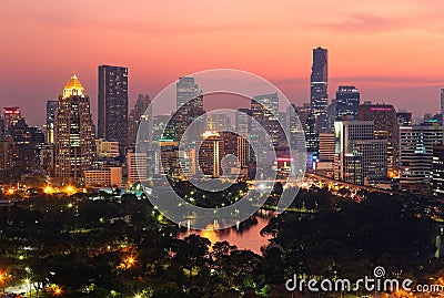 Urban skyline of Bangkok City at sunset, with famous landmark Mahanakhon Tower amid modern high rise buildings Stock Photo