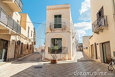 Urban street with typical mediterranean houses on the island Favignana in Sicily, Trapani, Italy Stock Photo