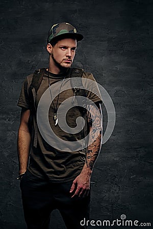 Backpacker in Camo green t shirt and tattoos on arms. Stock Photo