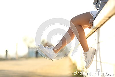 Urban teenager legs wearing sneakers Stock Photo