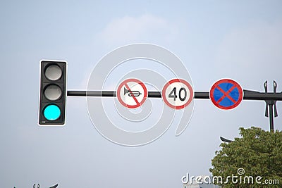 Urban traffic green light, prohibited car horn, speed limit sign, sky background Stock Photo