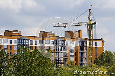 Urban view of silhouettes of high industrial tower crane above g Stock Photo