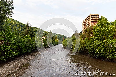 Urban views and decoration of the city Chiatura , Georgia. Blue sky with clouds. River and old houses Stock Photo
