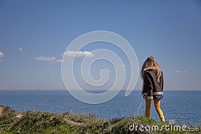 Girl walks above the sea Stock Photo