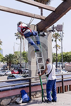 Urban workers spend repair work near the Olympic port Editorial Stock Photo