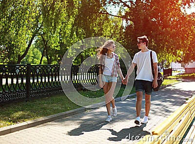 Urban young couple in love walking in sunny summer day, youth Stock Photo