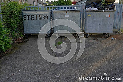 Large scale metal garbage containers in industrial zone in Urdorf. Editorial Stock Photo