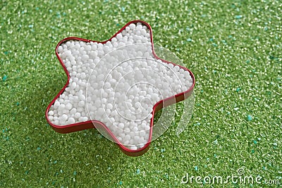 Urea fertilizer in star shape on green magnesium fertilizer Stock Photo