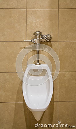 Urinal on Tile Wall Stock Photo