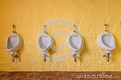 Urinals Men public in toilet room, wc. Stock Photo