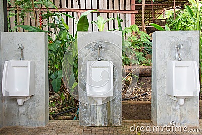 Urinals Men public in toilet room, wc Stock Photo