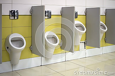 Urinals in a public toilet installed at various heights for high and low people Editorial Stock Photo