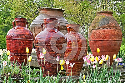Decorative traditional Romanian urns in a tulip garden Stock Photo