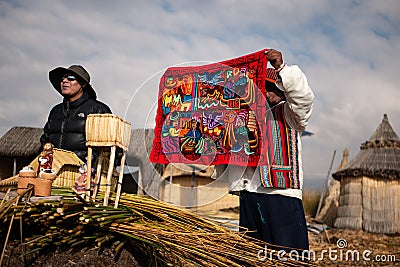 The Uros community showing off their handcrafts while tourists visit their floating island Editorial Stock Photo