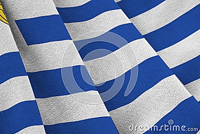 Uruguay flag with big folds waving close up under the studio light indoors. The official symbols and colors in banner Stock Photo