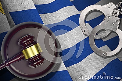 Uruguay flag with judge mallet and handcuffs in dark room. Concept of criminal and punishment, background for judgement Stock Photo