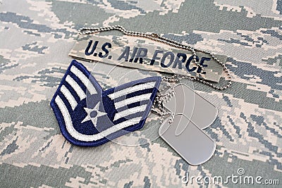 US AIR FORCE branch tape and Staff Sergeant rank patch and dog tags on digital tiger-stripe pattern Uniform Stock Photo