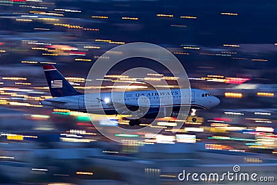 US Airways Airbus A319 airliner on approach to land at night at McCarran International Airport in Las Vegas Editorial Stock Photo