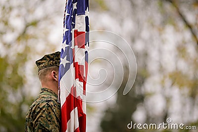 US Army soldier with US flag Editorial Stock Photo