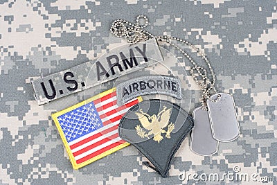 US ARMY Specialist rank patch, airborne tab, flag patch, with dog tag on camouflage uniform Editorial Stock Photo