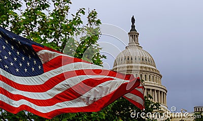 The US Capitol building with a waving American flag superimposed on the sky Stock Photo