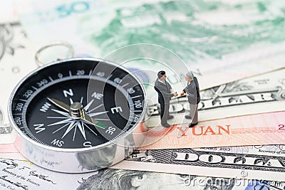 US and China finance economic direction, trade war, import and export deal and agreement concept, compass with miniature leader Stock Photo