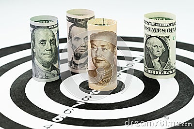 US and China financial trade war tariff strategy concept, US Dollar bank roll surround and targeting Chinese Yuan bank roll at th Stock Photo