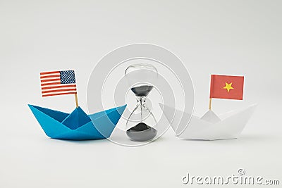 US and China financial trade war tariff strategy concept, hourglass / sandglass at the center between blue paper ship with Stock Photo