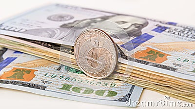 US Currency with one quarter coin Stock Photo