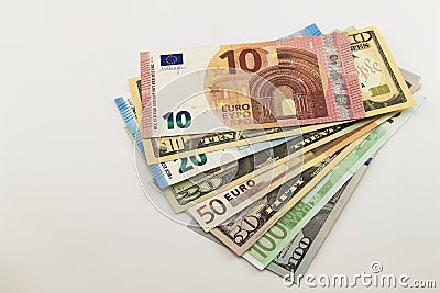 US dollar bills and Euro bills spread mixed on white background. Stock Photo