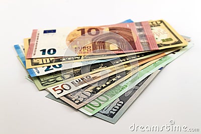 US dollar bills and Euro bills spread mixed on white background. Stock Photo