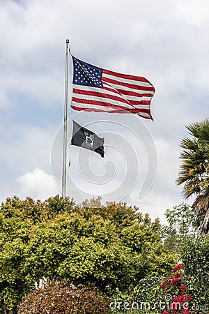 US Flag and POW MIA flag flying Editorial Stock Photo