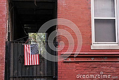 US flag seen attached to a side gate at a US home. Editorial Stock Photo